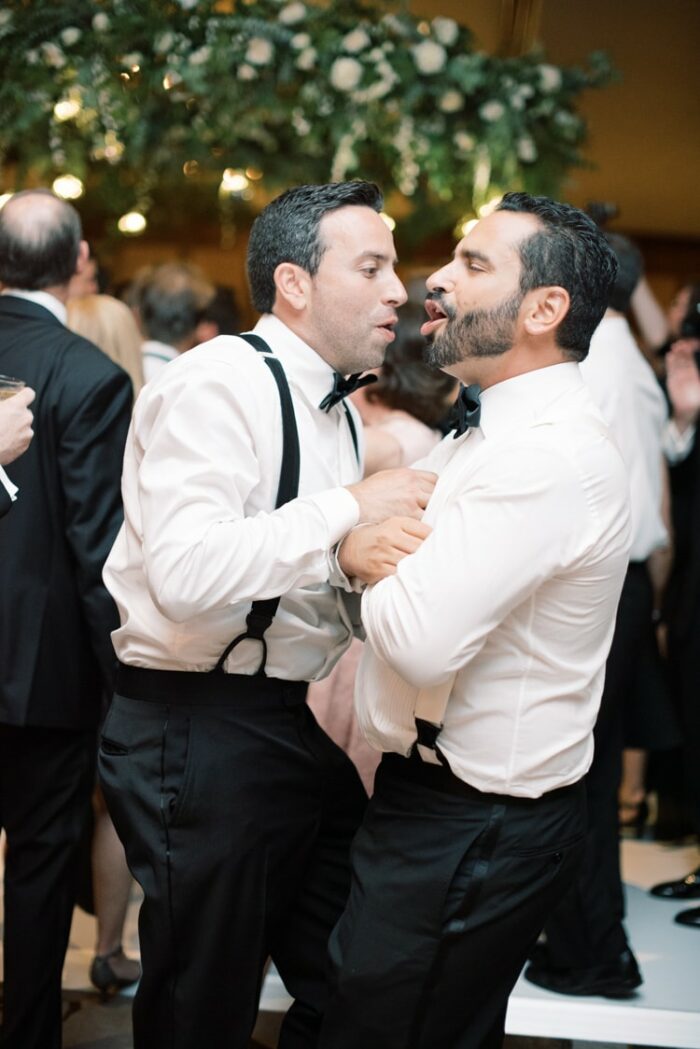 Groomsmen dancing together at wedding reception