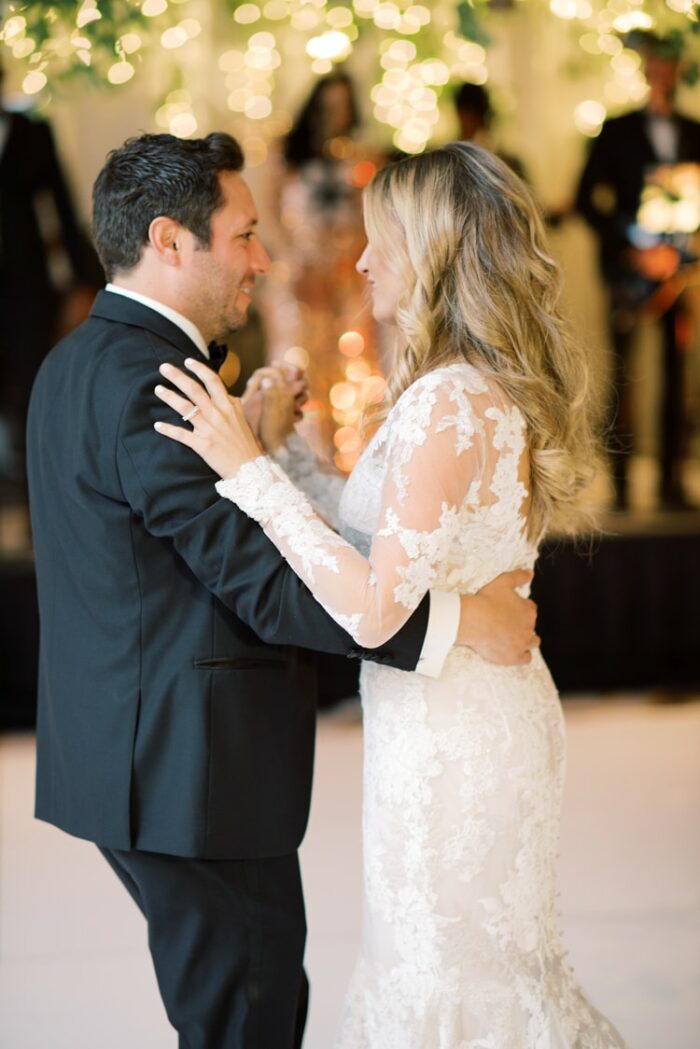 Bride and groom embracing each other during their first dance at the Ritz