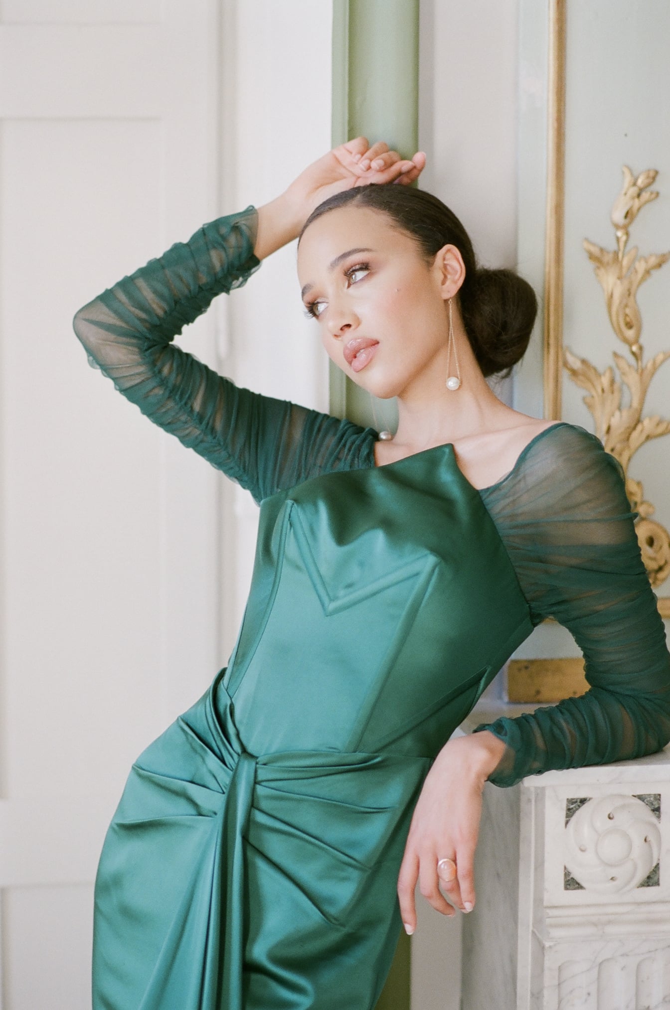 Bride in green dress looking away from camera