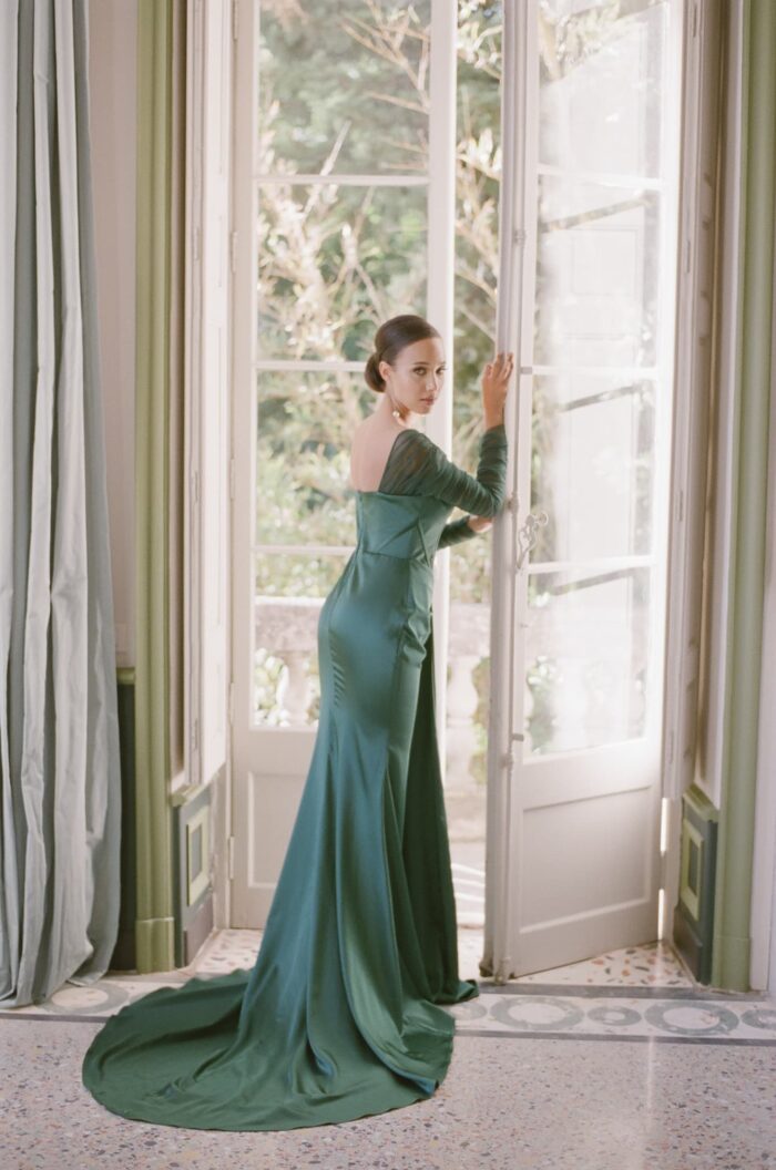 Bride standing in front of French window