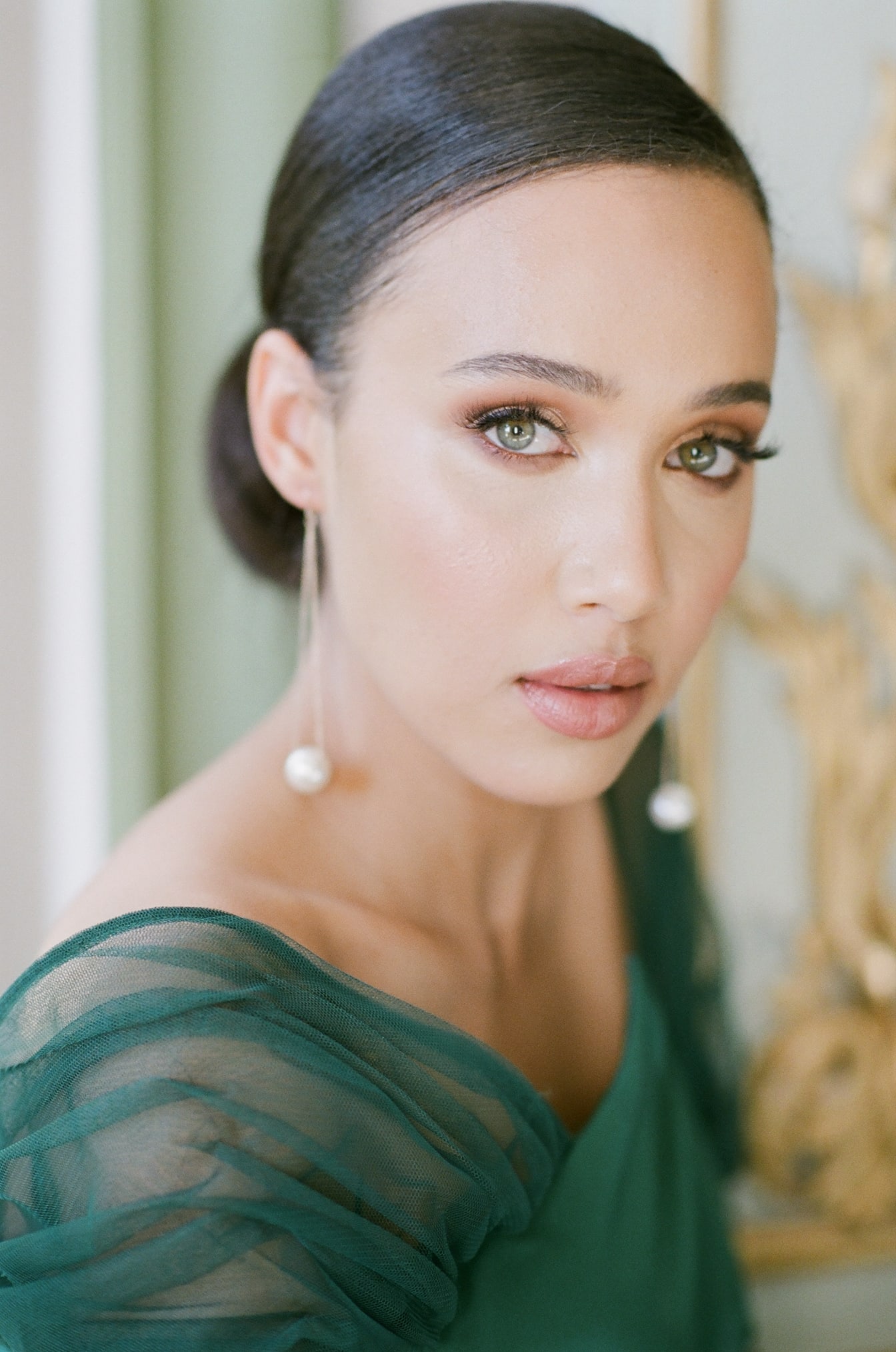 Closeup of bride in green dress