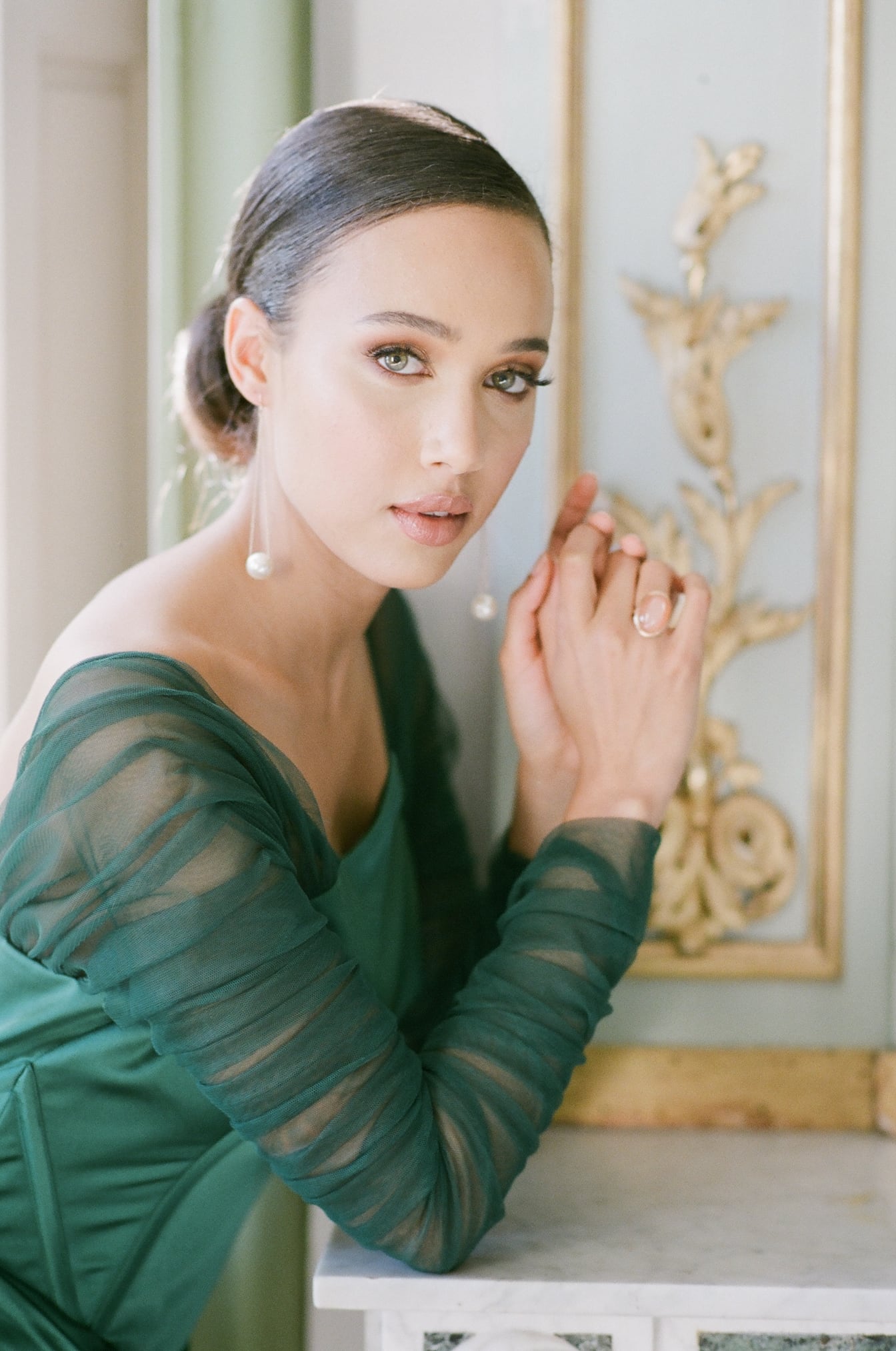 Bride leaning on French chateau wall