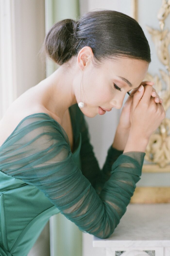 Bride in green dress looking down