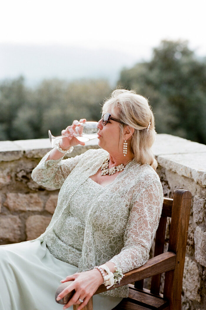 Mother of groom enjoying Italian wine