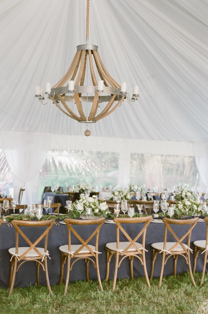Tent wedding reception tablescape with blue table linen