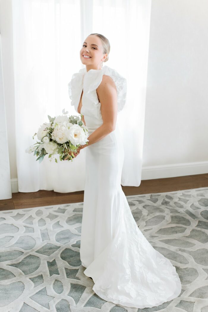 Chicago modern bride getting ready and smiling with her bouquet