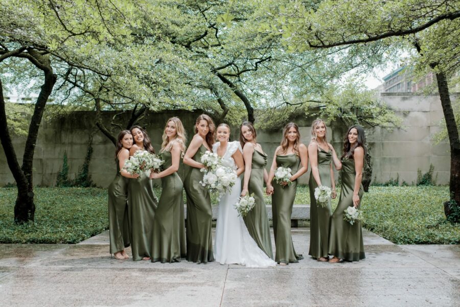 Bride with her bridesmaids smiling at Chicago Art Institute Garden