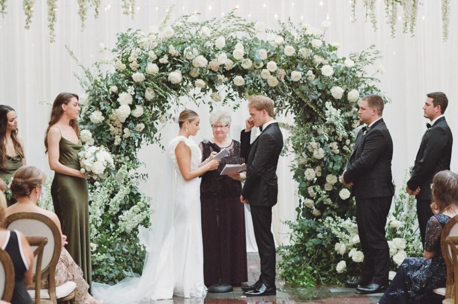 Bride reading her vow out loud to her groom
