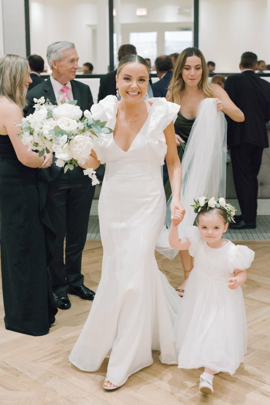 Bride with her flower girl smiling at camera at Chicago Illuminating Company
