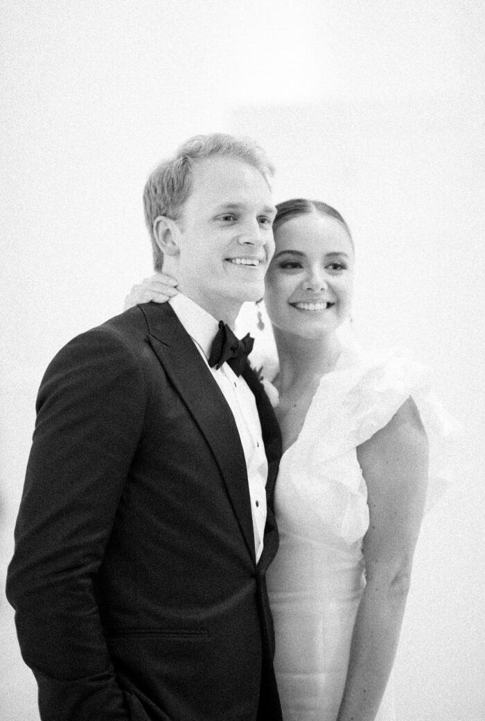 Bride and groom posing for their wedding guests