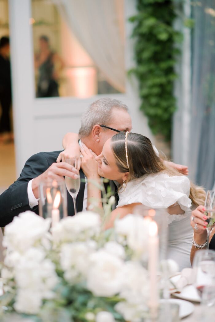 Bride embracing her dad after wedding speech