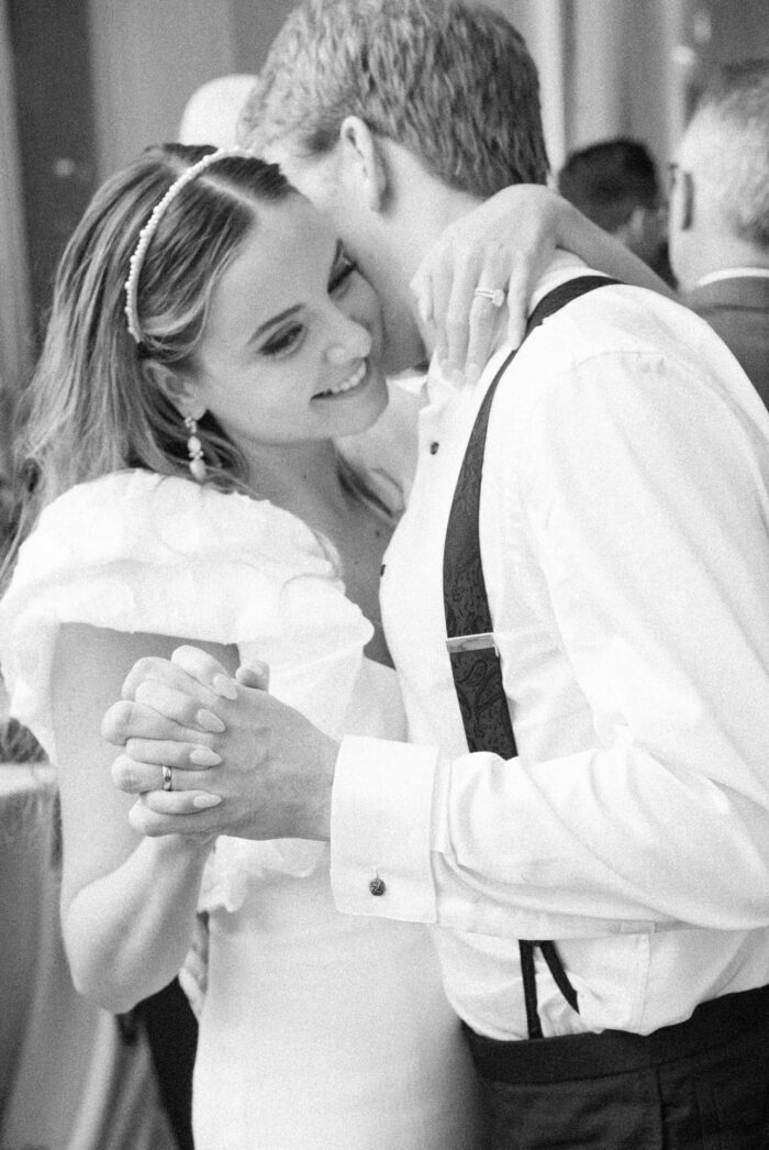 Bride and groom embracing each other during wedding dance