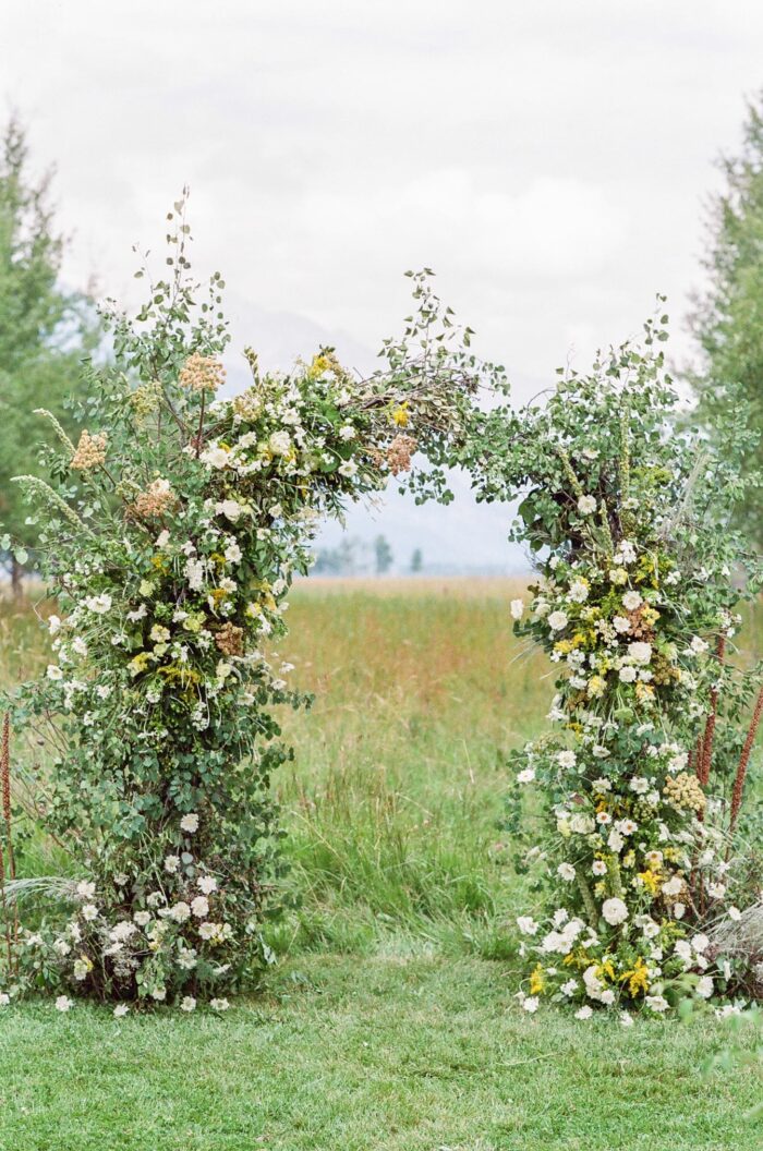 Floral ceremony arch in yellow and green