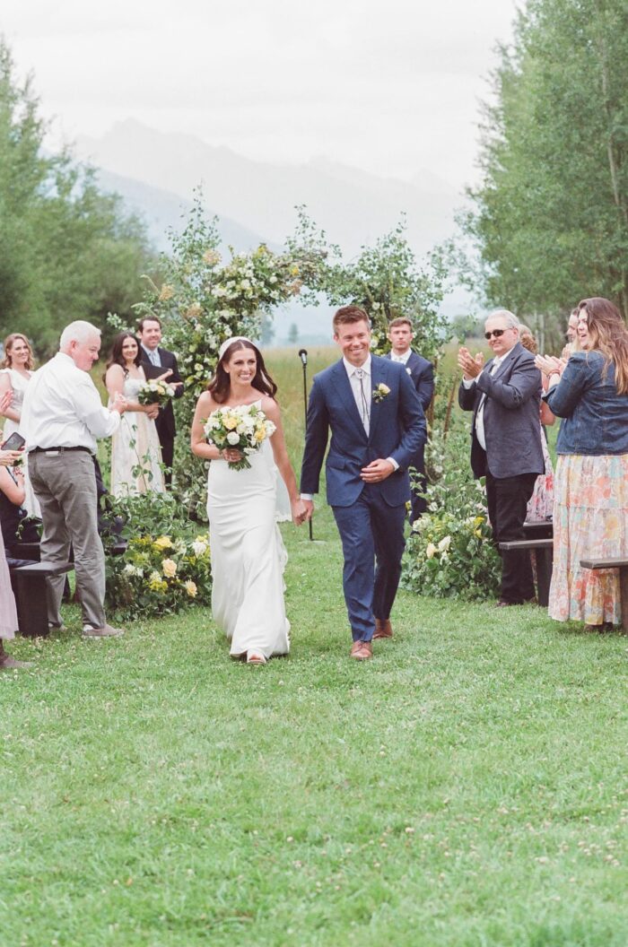 Bride and groom walking down the aisle after tying the knot at Snake River Ranch