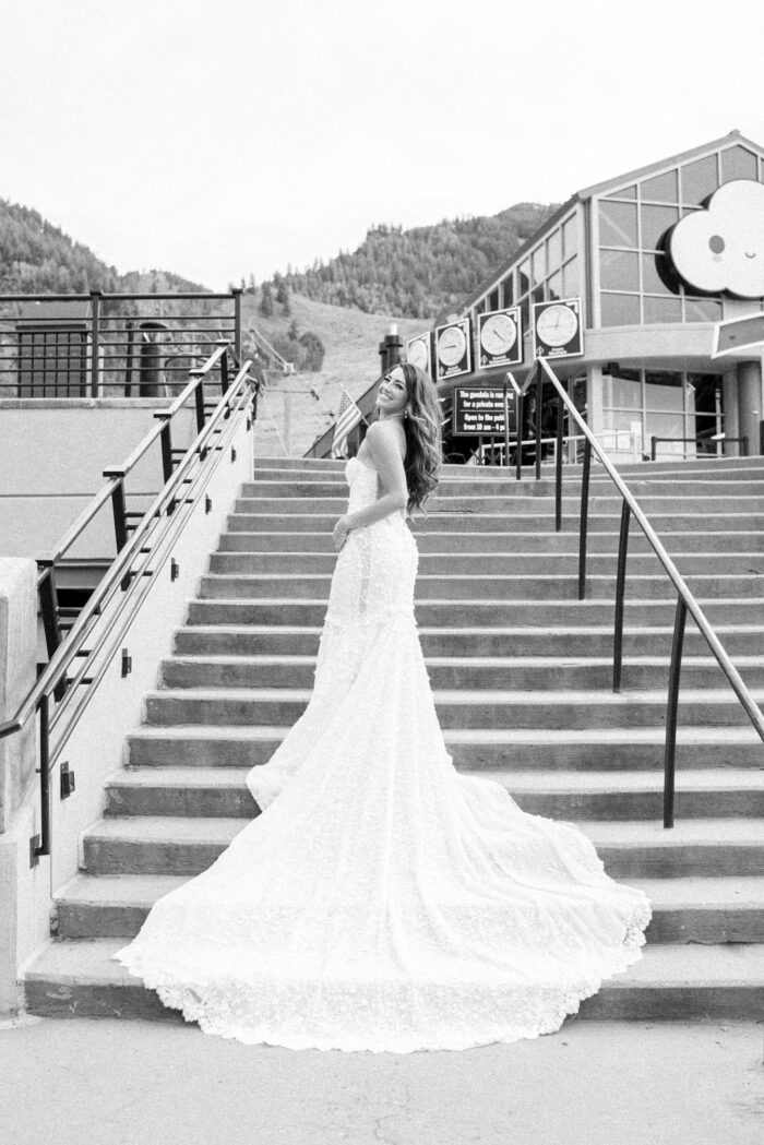 Galia Lahav bride standing at stairs at Aspen gondola