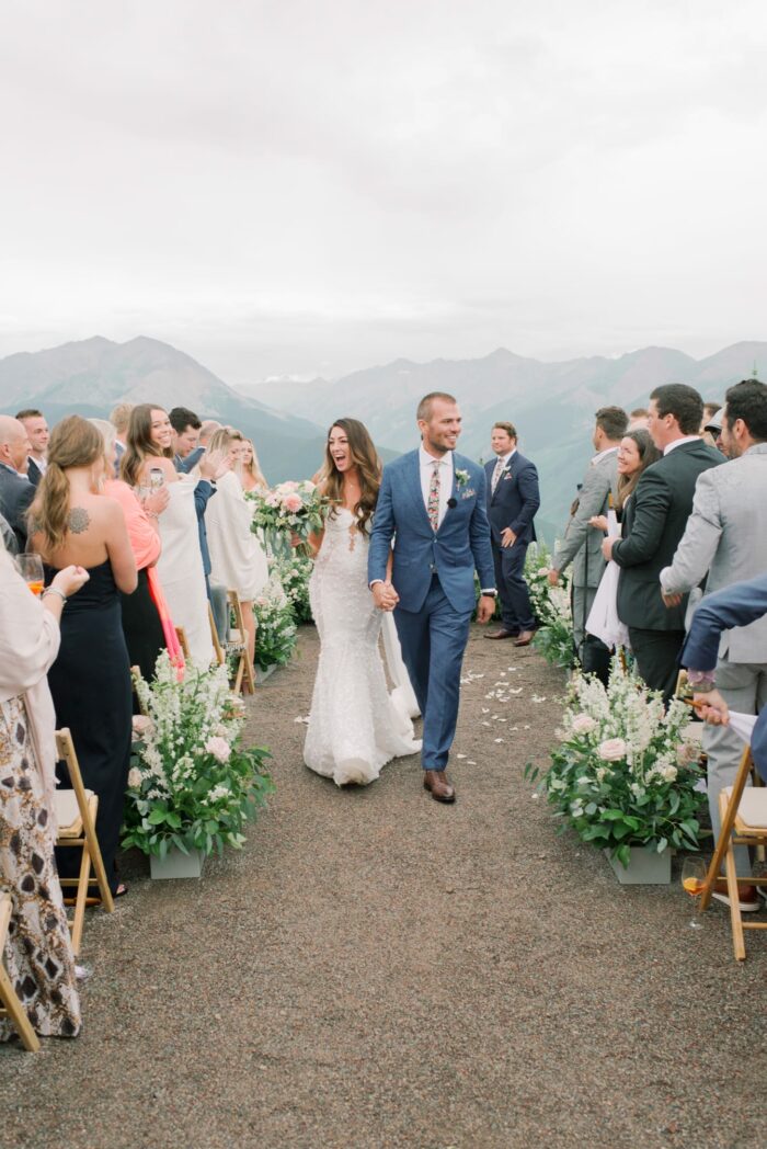 Bride and groom walking down the aisle at the Little Nell