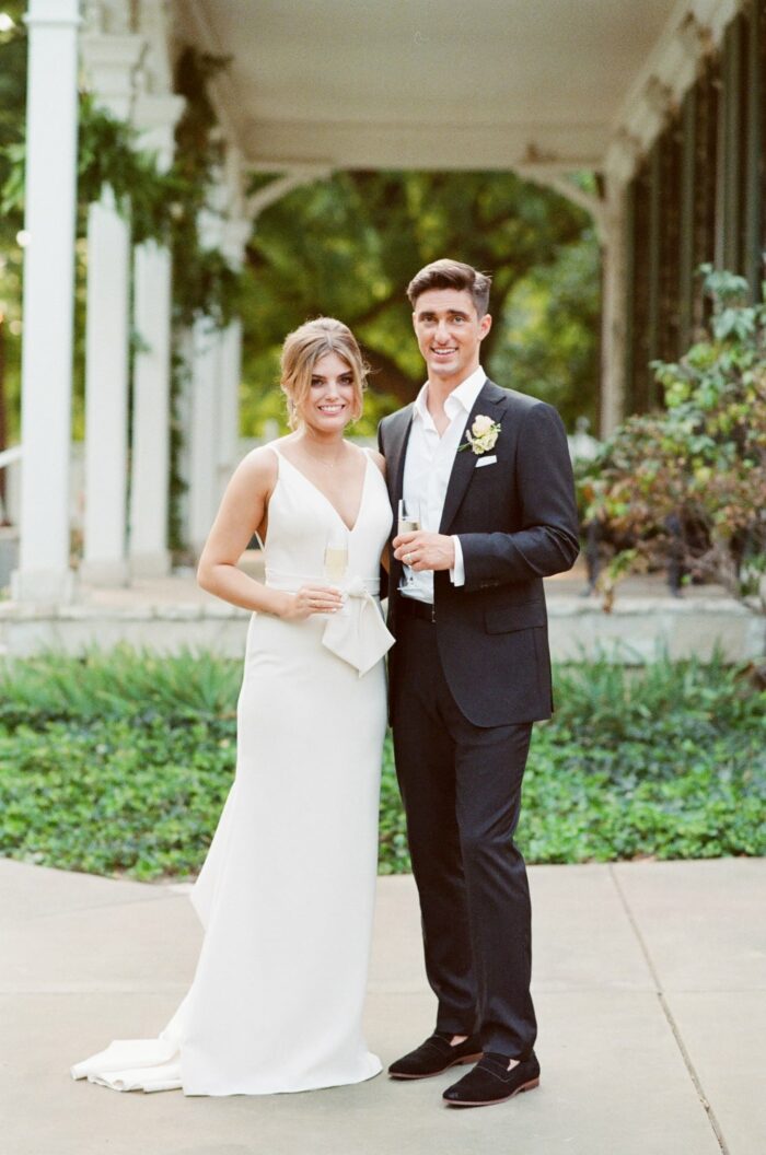 Bride and groom standing in front of Oakland House in St Louis