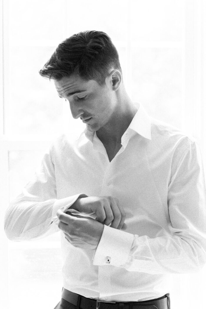 St Louis groom putting his cufflinks on