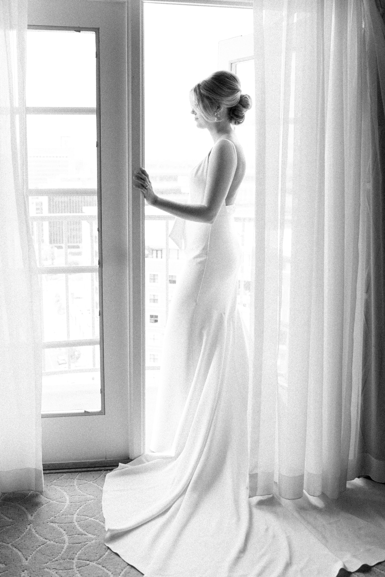 Bride standing in between windows at her St Louis wedding