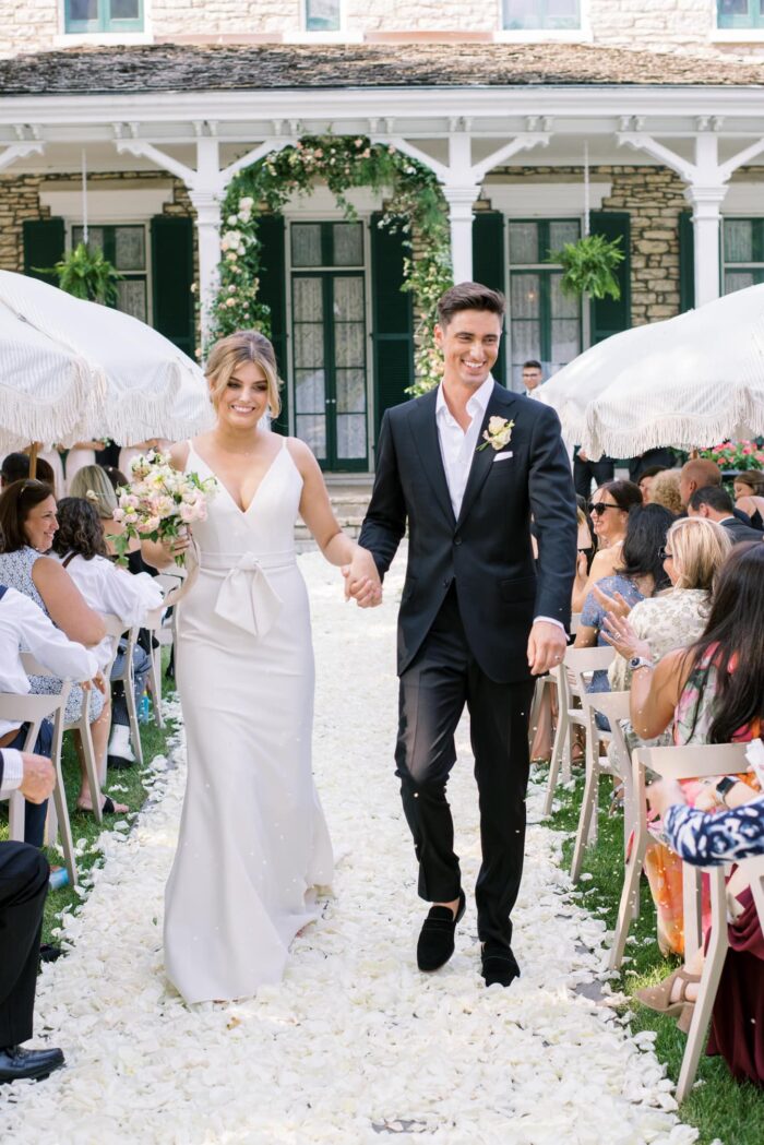 Bride and groom walking down the aisle together in St Louis