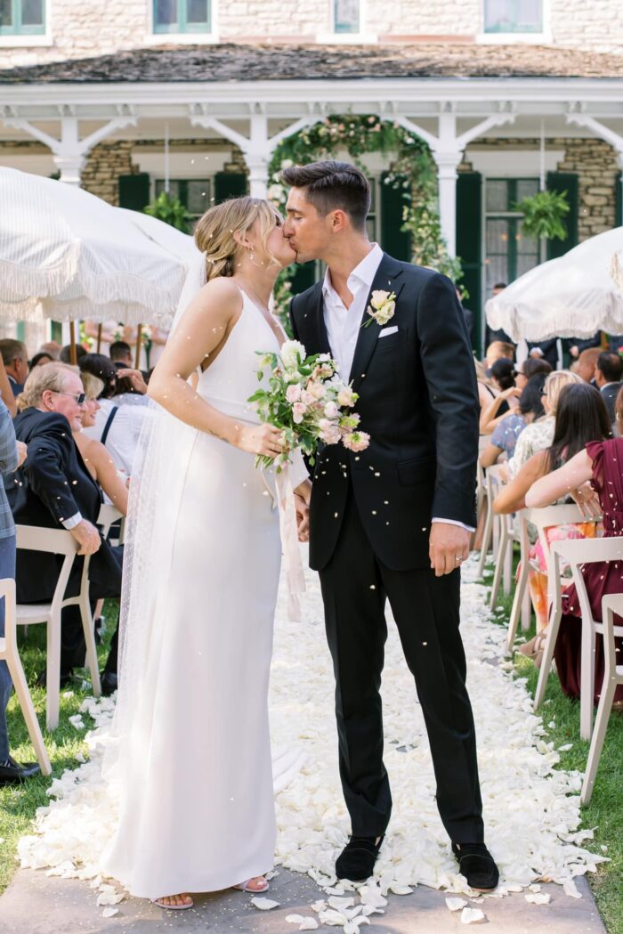 Bride and groom kissing each other during tent wedding in St Louis