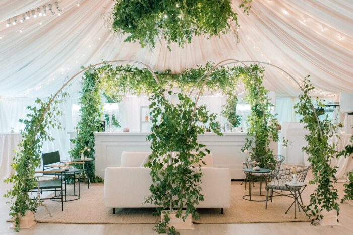 Green floral arches surrounding the bar