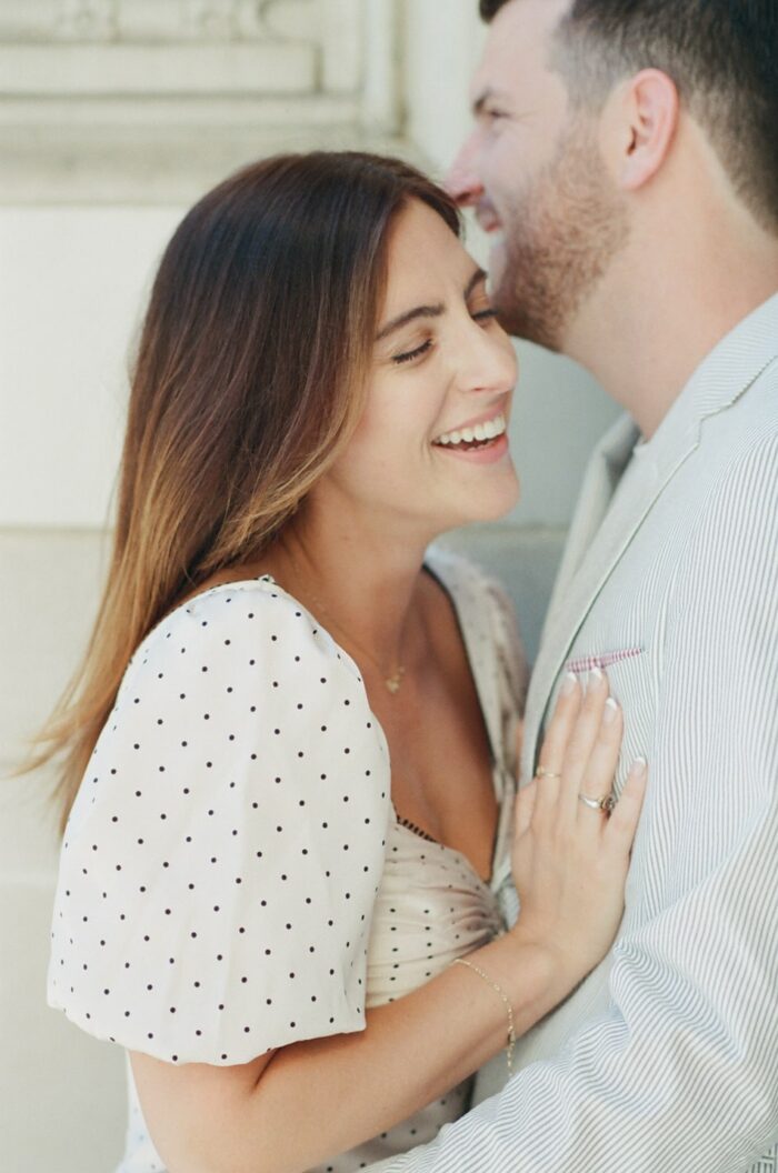 Groom whispering into his bride's ear during Chicago Engagement