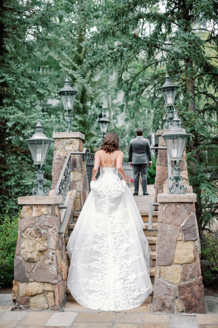 Bride walking up the bridge of the Chateau in Beaver Creek