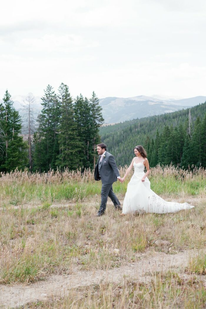 Bride and groom walking on top of Beaver Creek mountain