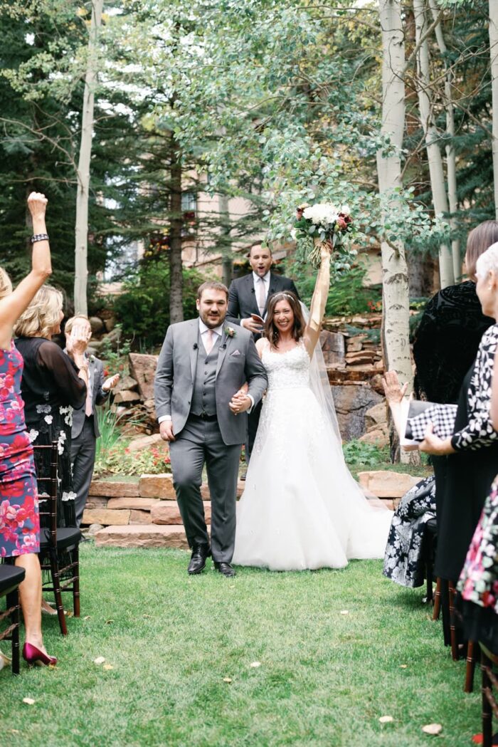 Bride and groom walking down the aisle together at the Chateau in Beaver Creek
