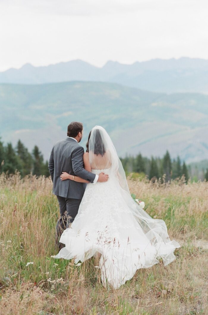 bride and groom embracing each other while enjoying Beaver Creek mountain views