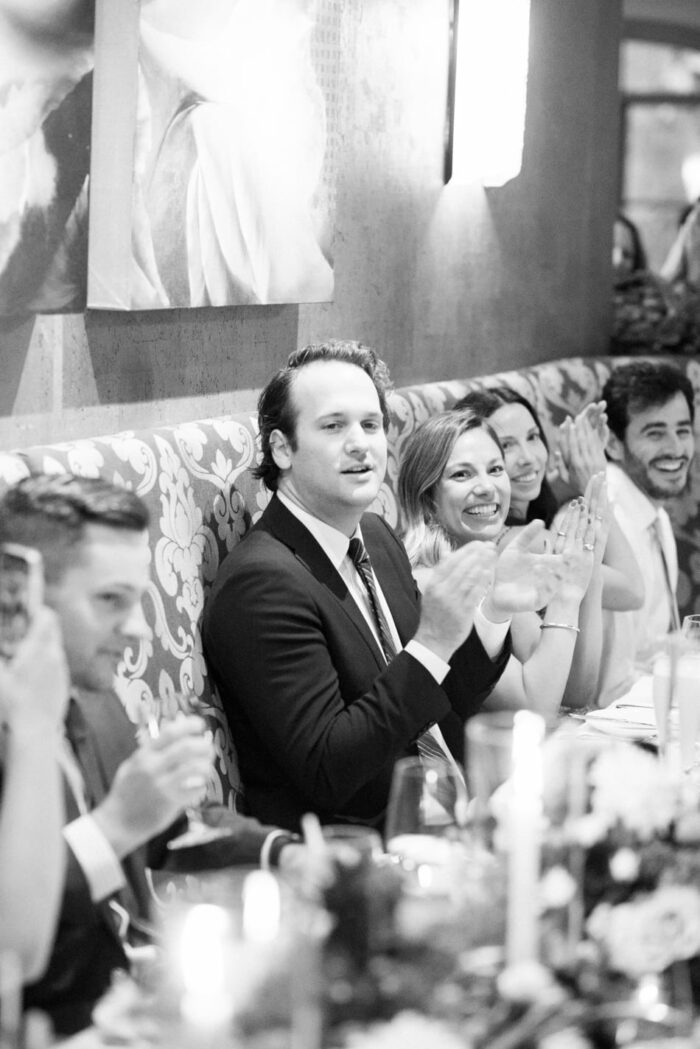 Wedding guests cheering during wedding reception