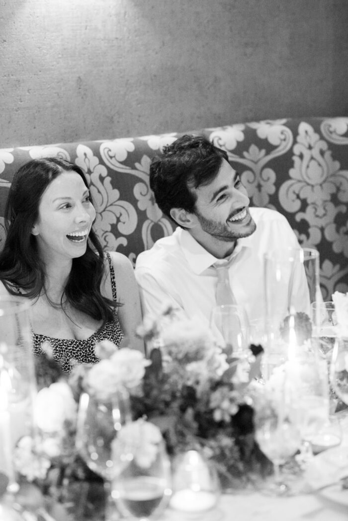 Wedding guests laughing during wedding reception speeches