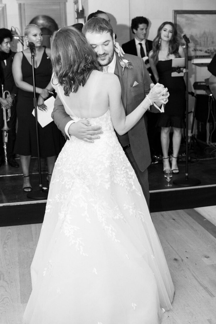 Bride and groom embracing each other during first dance