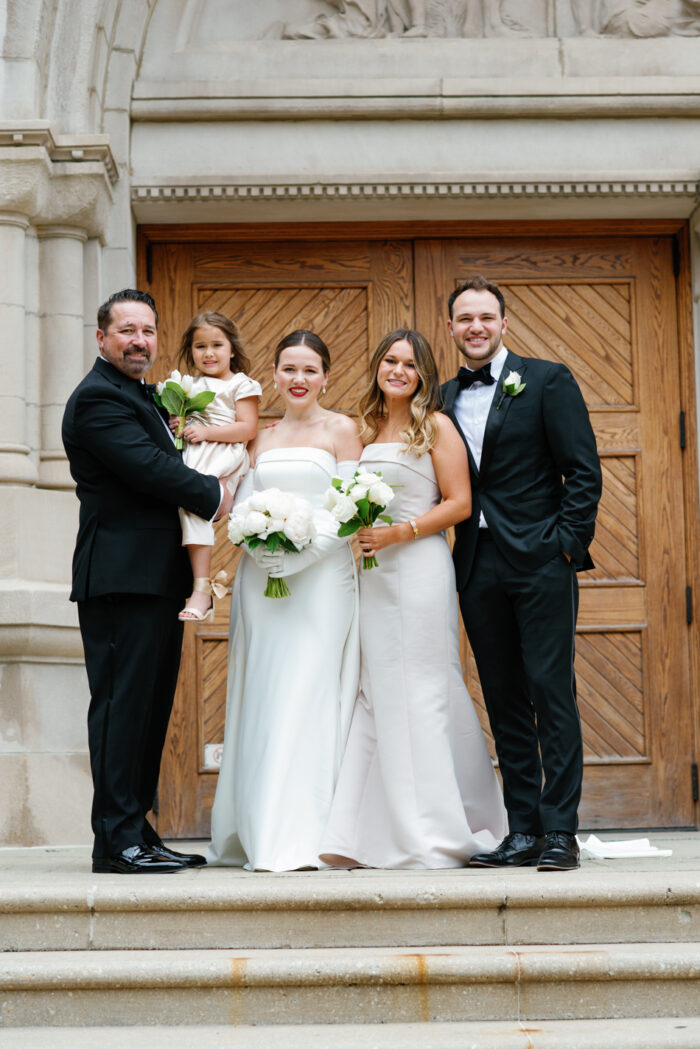 Family picture in front of St Vincent de Paul Chicago church