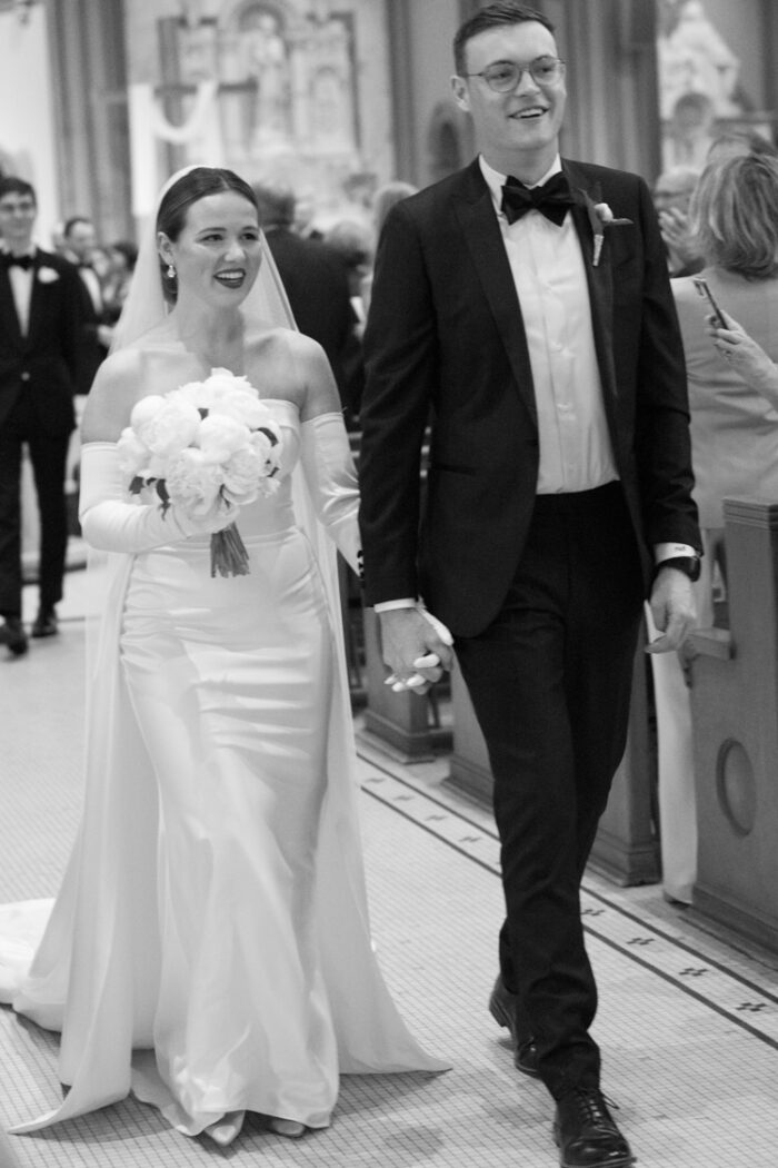 Bride and groom walking down the aisle after church wedding