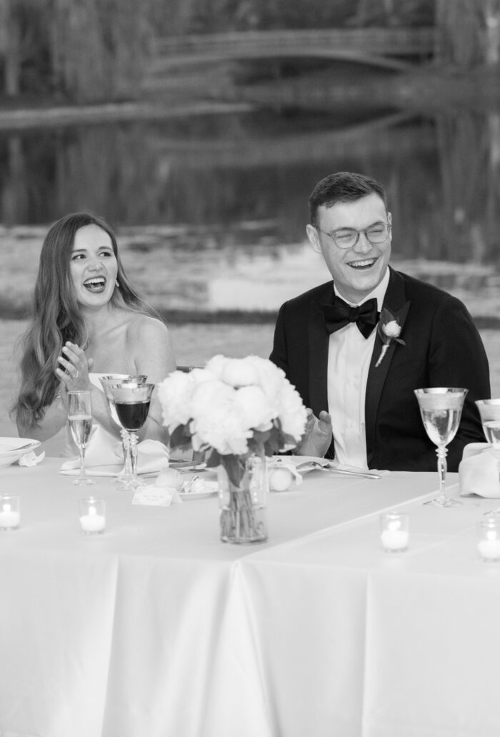 Bride and groom laughing at their classic wedding reception