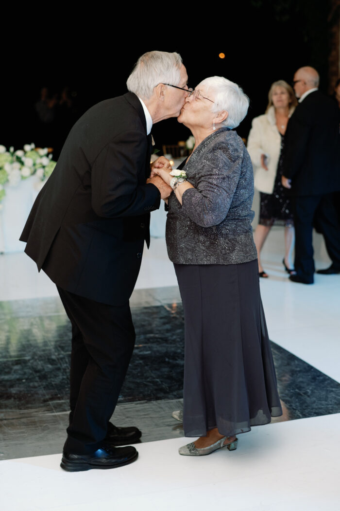 Grandparents kissing each other during dance at Chicago Botanic Garden wedding