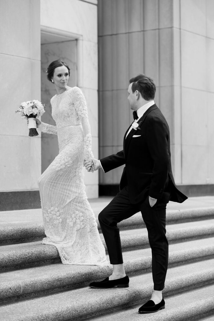 Bride and groom walking into their Chicago Old Post Office wedding reception