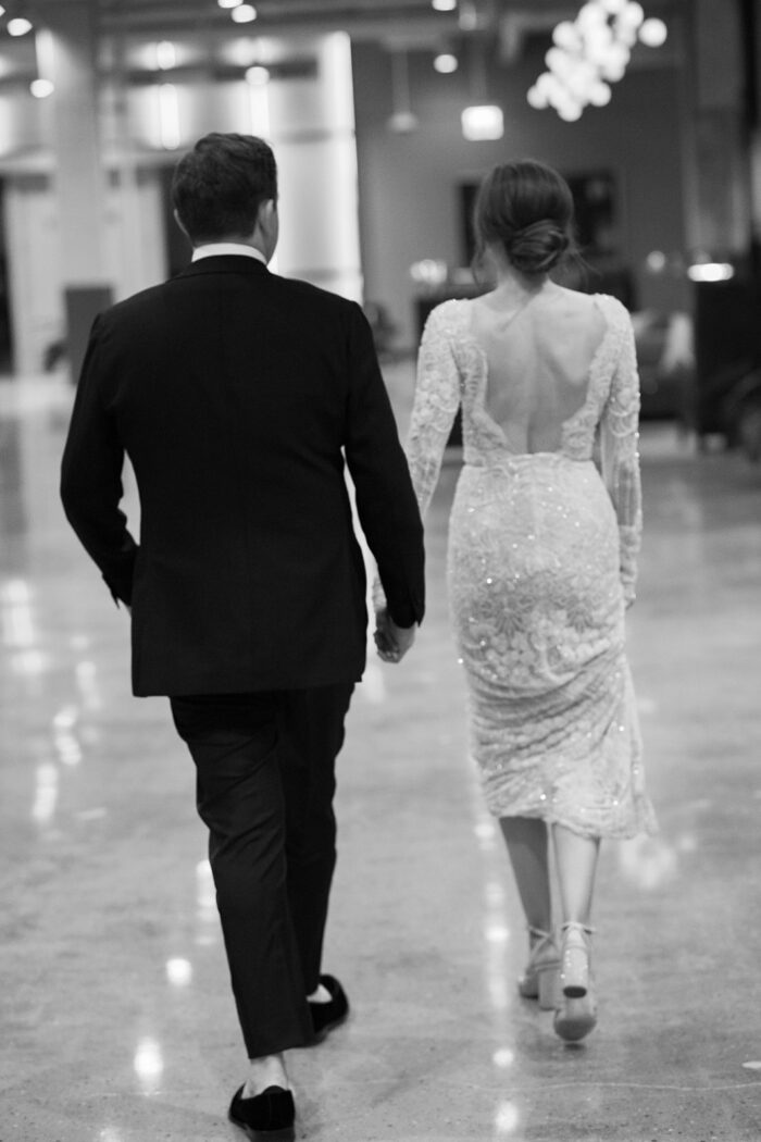 Bride and groom hand in hand at the Chicago Old Post Office