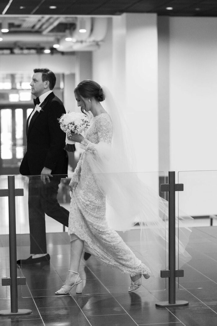 Bride and groom walking to the escalator at the Chicago Old Post Office