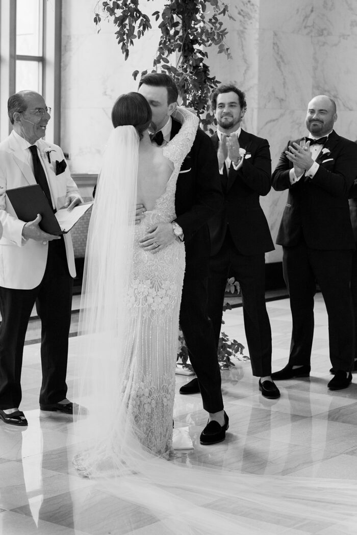 Bride and groom's first kiss at wedding ceremony at Chicago Old Post Office