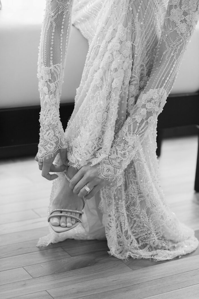Bride putting her wedding shoes on at the Langham in Chicago