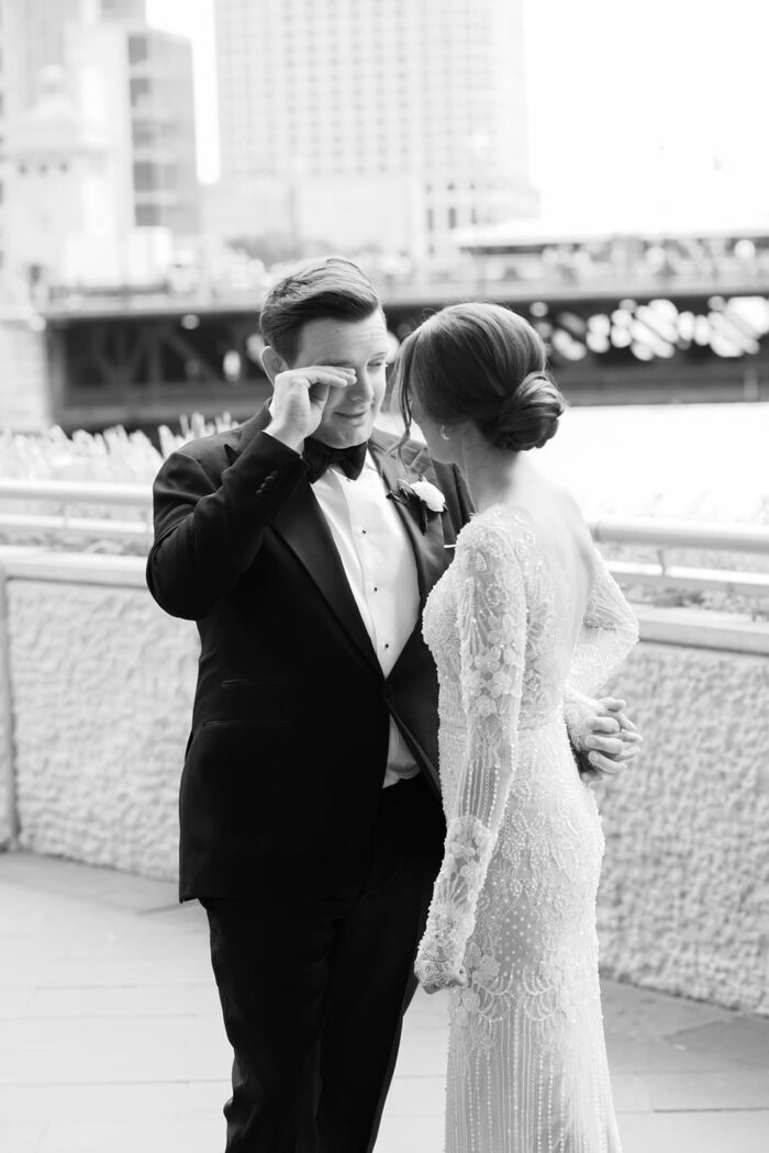 Firs look of bride and groom in front of the Langham