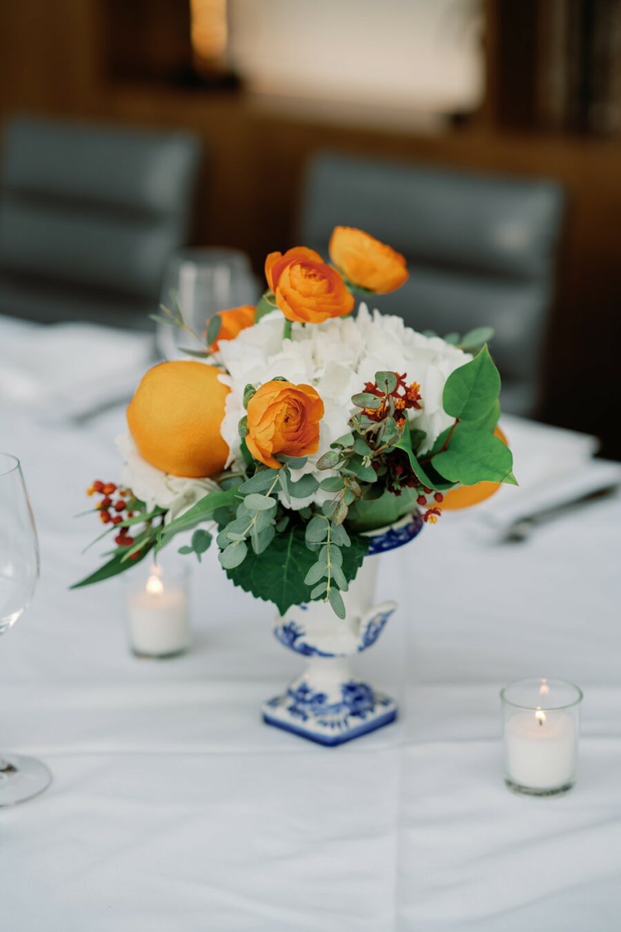 White and orange floral centerpiece by HMR Design