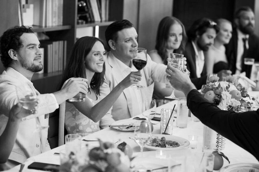Bride and groom cheering with their guests