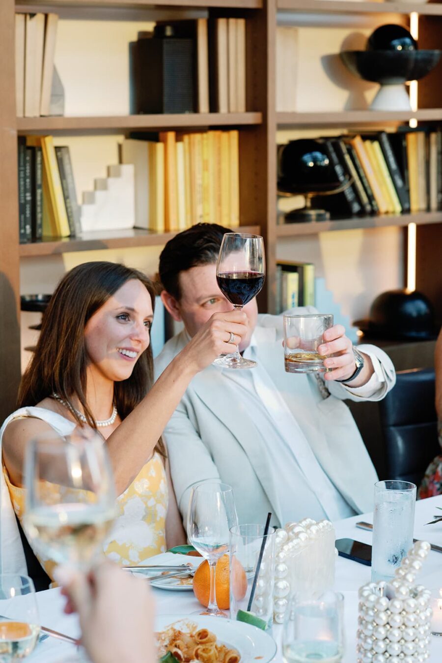 Bride and groom cheering during their Chicago rehearsal dinner