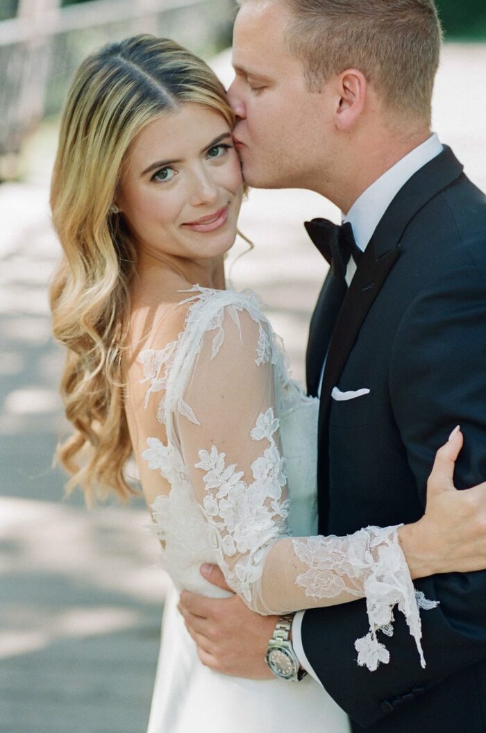 Groom kissing his bride during their Aspen wedding