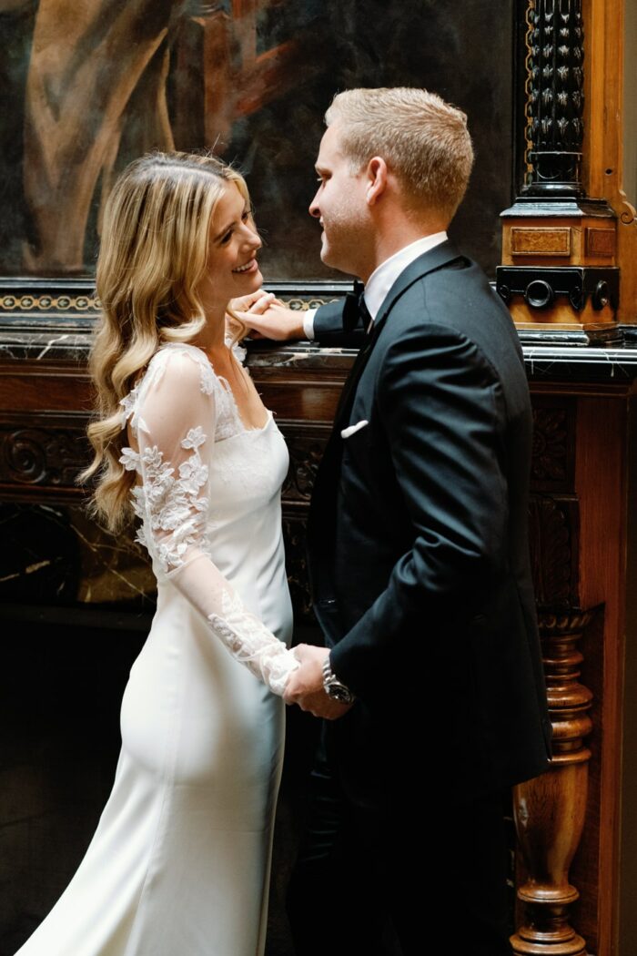 Bride and groom embracing each other at the lobby of Hotel Jerome in Aspen