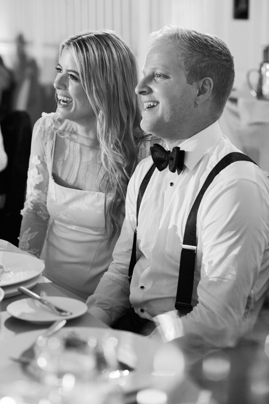Bride and groom laughing during their wedding reception at Hotel Jerome